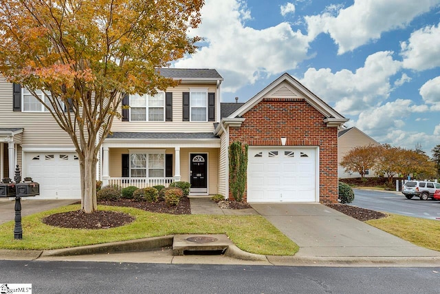 view of front property featuring a porch and a garage