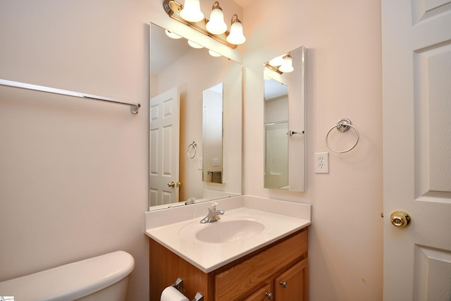 bathroom featuring vanity and toilet