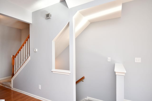 stairs with hardwood / wood-style floors