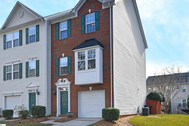 townhome / multi-family property featuring a garage and central AC unit