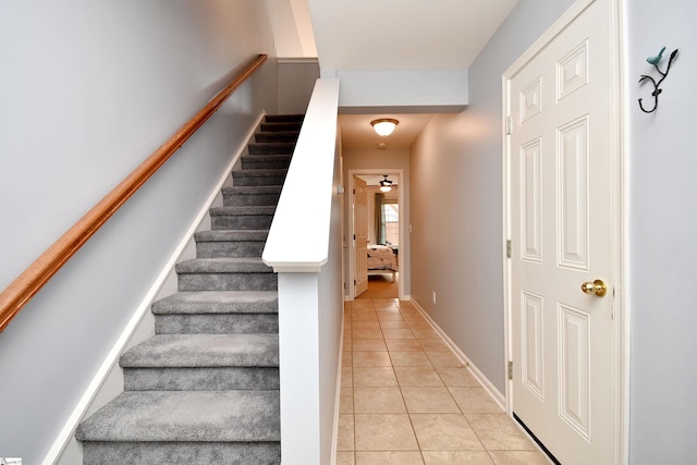 stairway with tile patterned floors