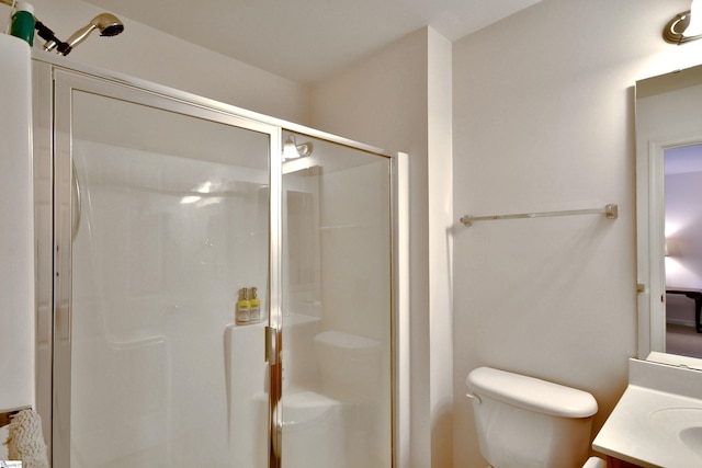 bathroom featuring vanity, toilet, and an enclosed shower