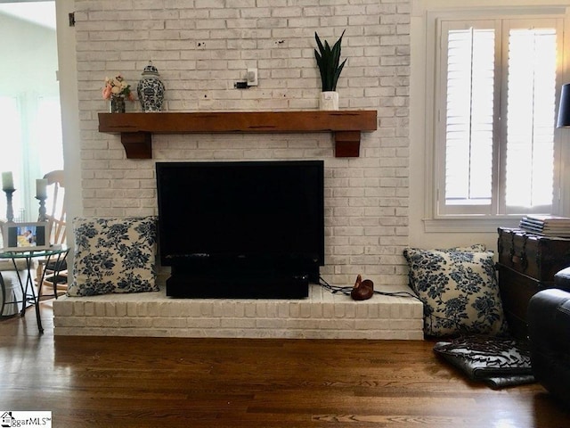 living room featuring a fireplace, hardwood / wood-style floors, and plenty of natural light