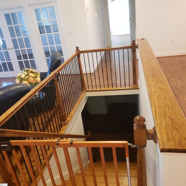 stairs with hardwood / wood-style flooring