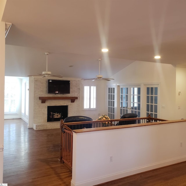 kitchen featuring ceiling fan, a fireplace, and hardwood / wood-style flooring