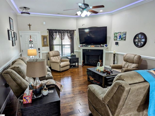 living room featuring ceiling fan, dark hardwood / wood-style flooring, and ornamental molding