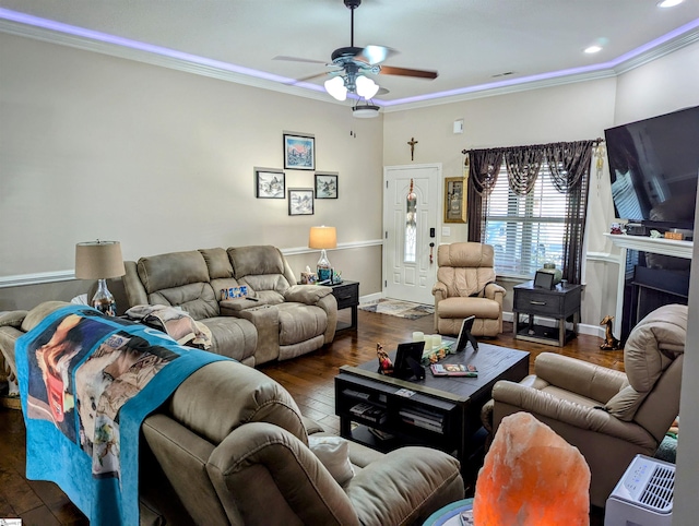 living room featuring ornamental molding, ceiling fan, and dark wood-type flooring