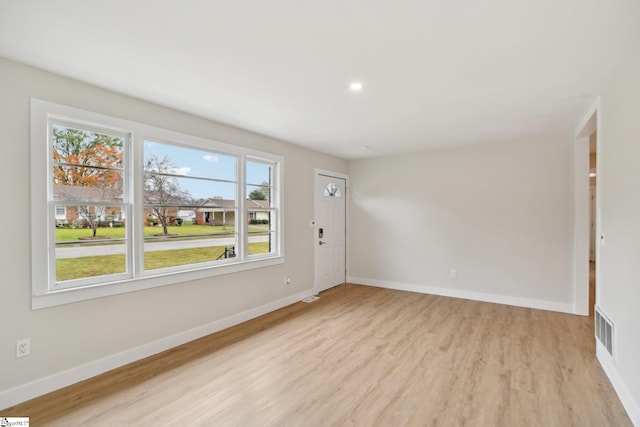 unfurnished room featuring a healthy amount of sunlight and light wood-type flooring