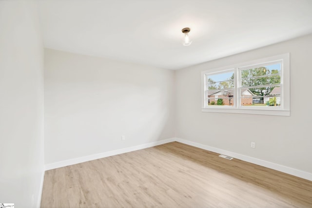 spare room with light hardwood / wood-style flooring