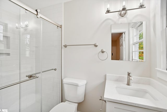 bathroom with vanity, toilet, and an enclosed shower