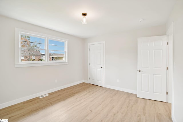 spare room with light hardwood / wood-style flooring