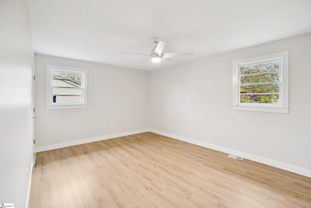 spare room with light wood-type flooring and ceiling fan