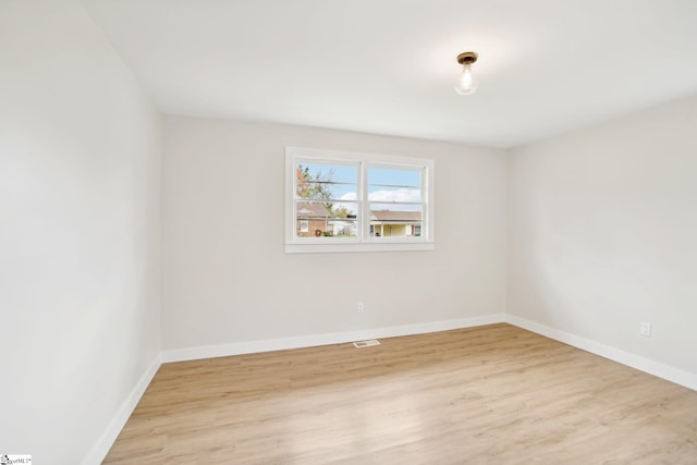 unfurnished room with light wood-type flooring