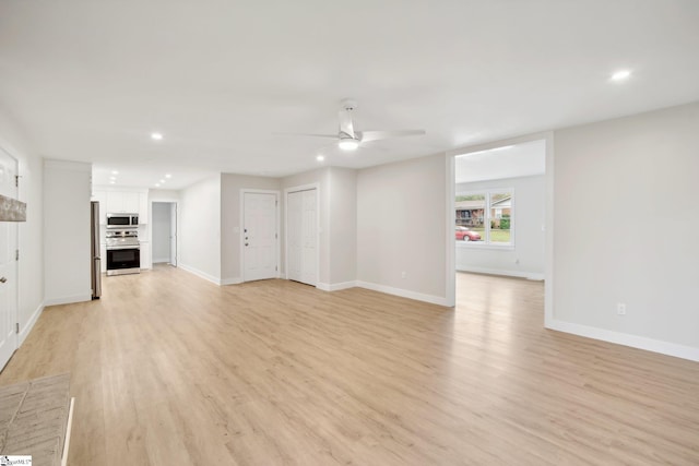 unfurnished living room featuring ceiling fan and light hardwood / wood-style floors