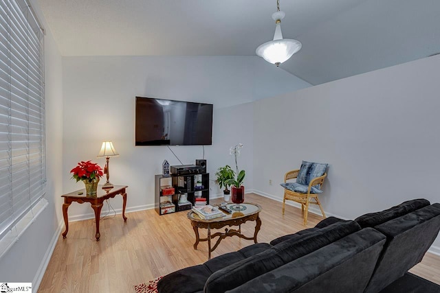 living room featuring light wood-type flooring and lofted ceiling