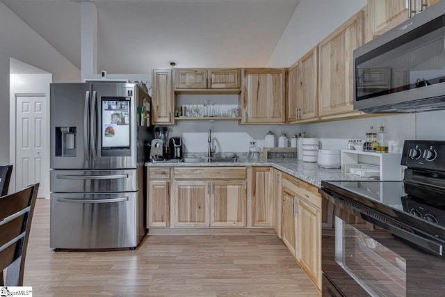 kitchen featuring light hardwood / wood-style floors, light stone counters, stainless steel appliances, and light brown cabinetry