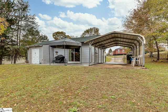 view of outbuilding with a yard and a carport