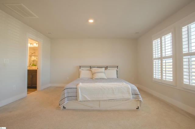 carpeted bedroom with ensuite bathroom