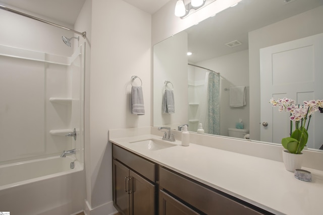 full bathroom featuring vanity, shower / bath combination with curtain, and toilet