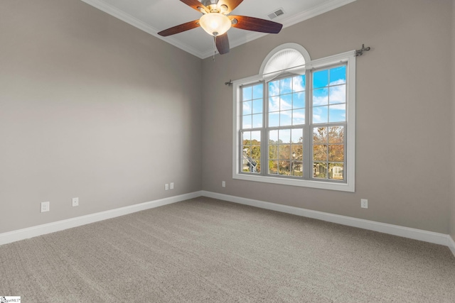 empty room with carpet flooring, crown molding, and ceiling fan