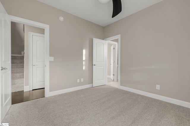 unfurnished bedroom featuring ceiling fan, a closet, and carpet floors