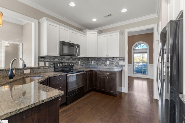 kitchen with white cabinetry, sink, dark hardwood / wood-style flooring, black appliances, and ornamental molding