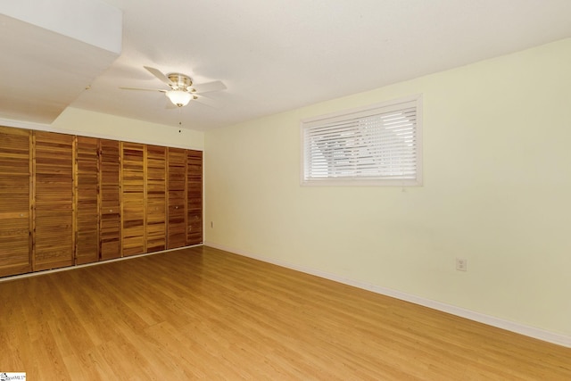 unfurnished bedroom with ceiling fan and wood-type flooring