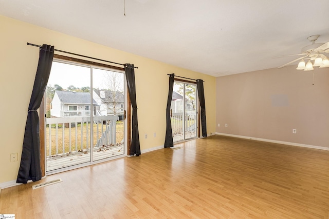 spare room featuring light wood-type flooring and ceiling fan