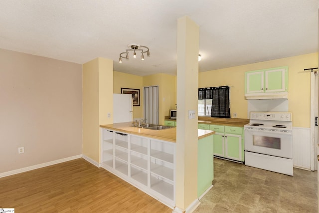 kitchen with light wood-type flooring, white appliances, green cabinets, and sink