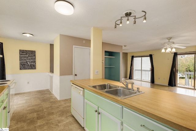 kitchen with wood counters, sink, white appliances, and green cabinetry