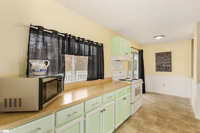 kitchen featuring white electric range oven, green cabinetry, and custom exhaust hood