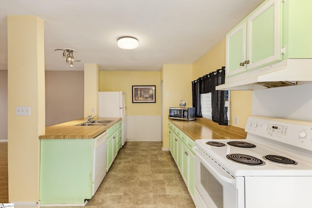 kitchen featuring green cabinets, white appliances, and sink