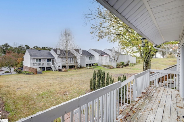 wooden deck featuring a lawn