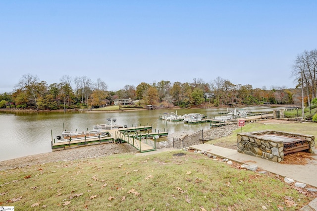 dock area with a yard and a water view