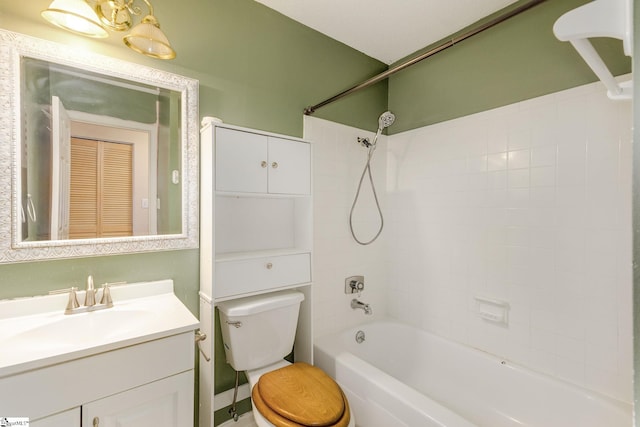 full bathroom with vanity, tiled shower / bath combo, and toilet