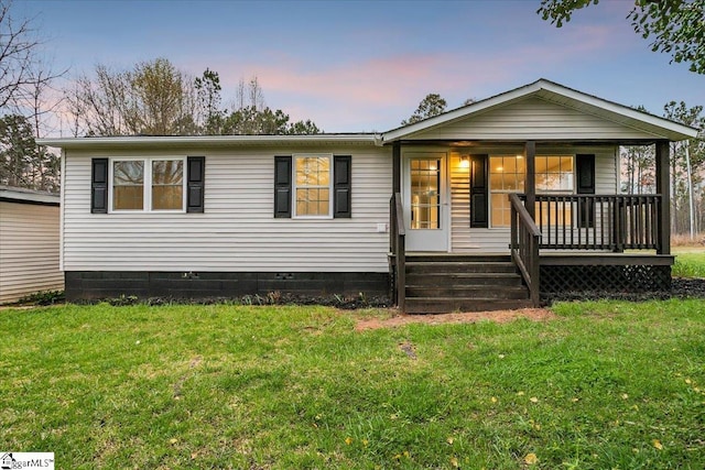 view of front of house with a lawn and covered porch