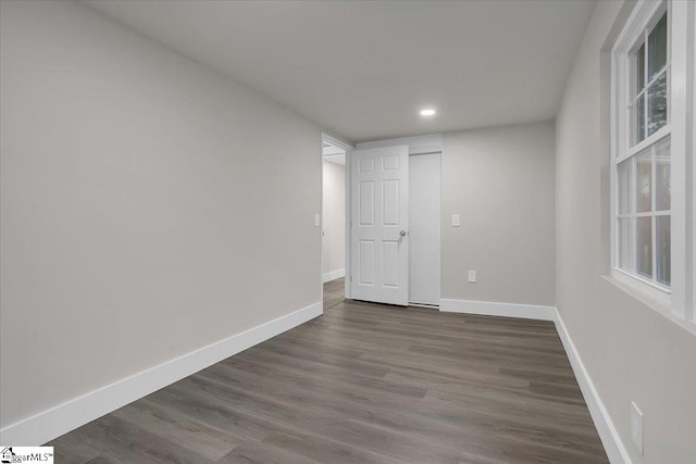 empty room with dark wood-type flooring