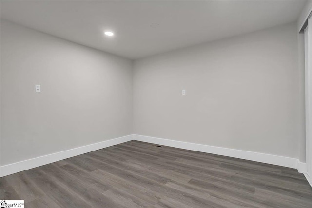 spare room with dark hardwood / wood-style flooring