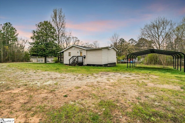 yard at dusk featuring a carport