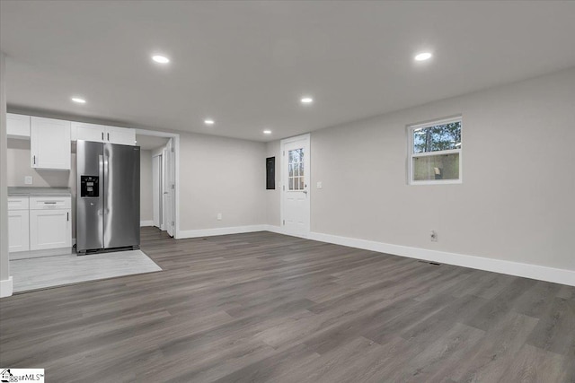 kitchen with hardwood / wood-style floors, white cabinetry, and stainless steel fridge with ice dispenser