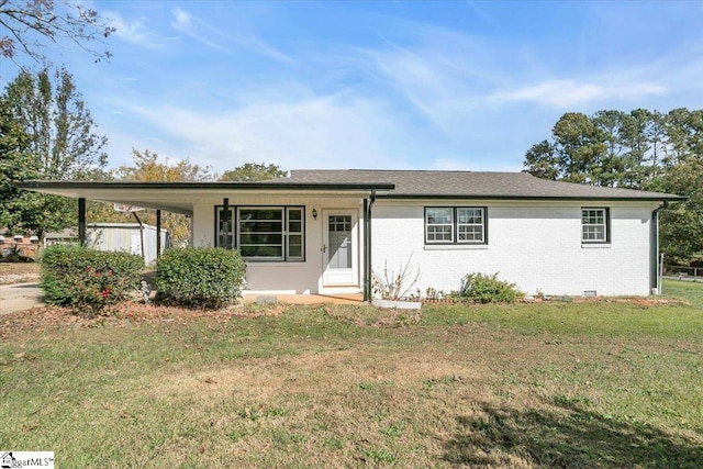 view of front facade with a carport and a front yard