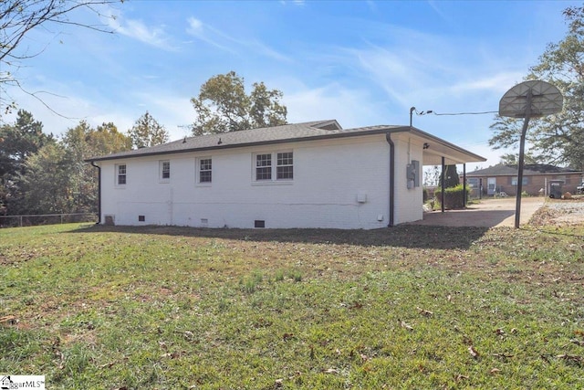 rear view of property with a yard