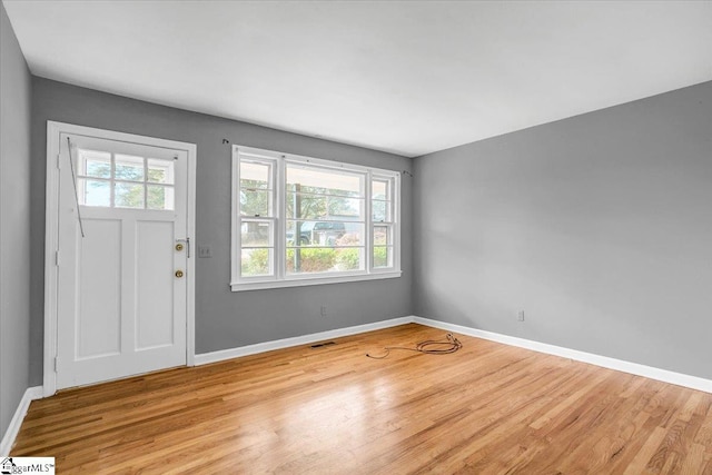 entrance foyer with a wealth of natural light and light hardwood / wood-style floors