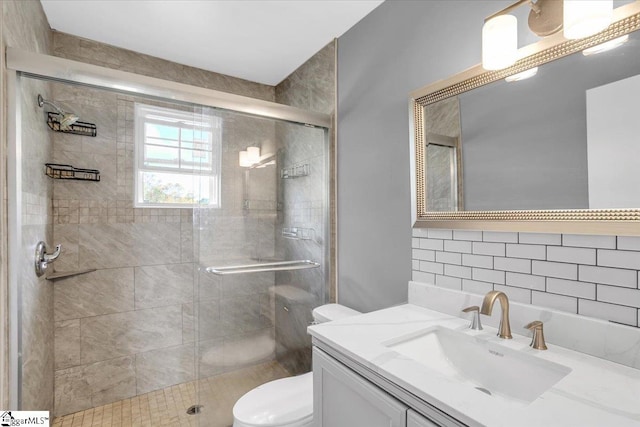 bathroom with vanity, toilet, and an enclosed shower