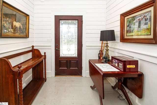 entrance foyer featuring wooden walls