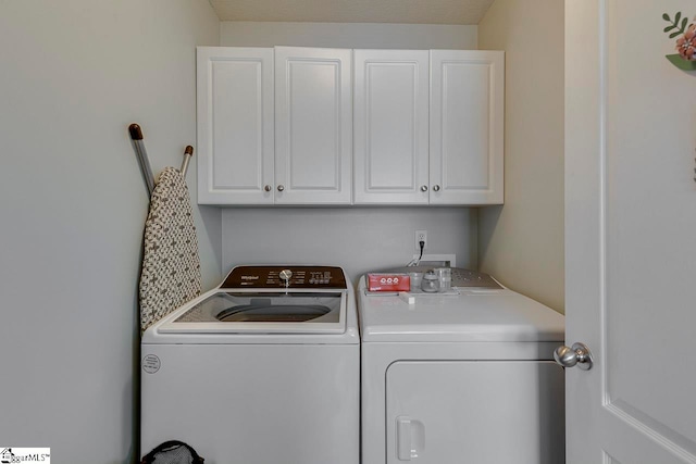 laundry room with cabinets and washer and clothes dryer