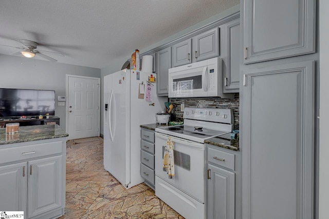 kitchen featuring decorative backsplash, dark stone counters, a textured ceiling, white appliances, and ceiling fan