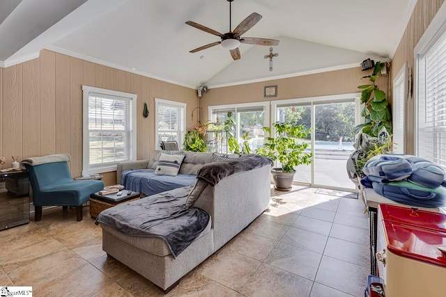 tiled living room with ceiling fan, wood walls, lofted ceiling, and ornamental molding