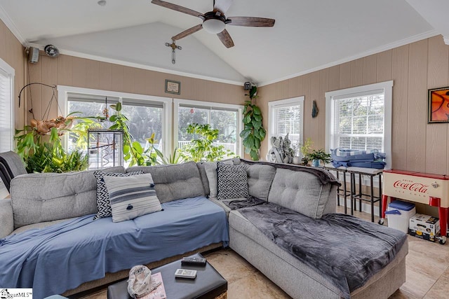 living room featuring ceiling fan, lofted ceiling, crown molding, and wooden walls