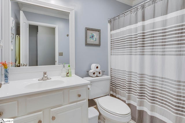 bathroom featuring vanity, toilet, and ornamental molding